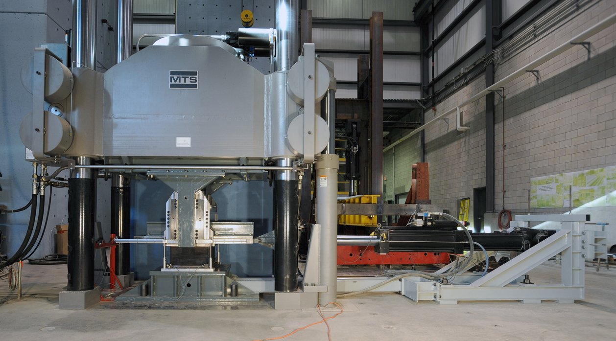 Compression–shear characterization of a bridge isolator